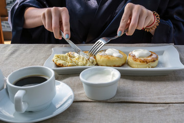Fototapeta na wymiar breakfast consisting of pancake with sour cream and coffee
