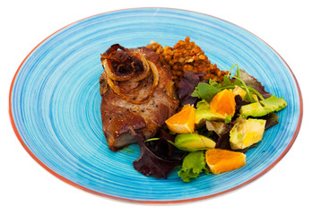 Baked pork shank with lentils and salad