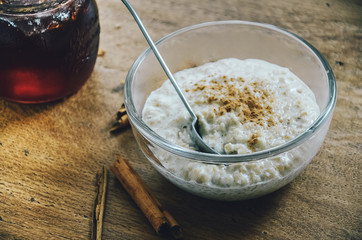 Creamy porridge with pinch of cinnamon and berry compote. Healthy start of the day, simple breakfast, warm meal for cold days.