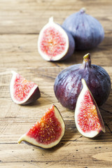 Figs are Fresh ripe whole and cut into a wooden old background.