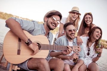 Man play guitar for his friends