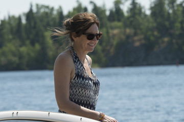 Woman standing on a boat, Lake of The Woods, Ontario, Canada