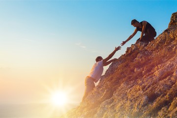 Man Rock Climbing with another, Man Helping concept