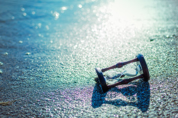 Hourglass in the water by the sea, ocean.