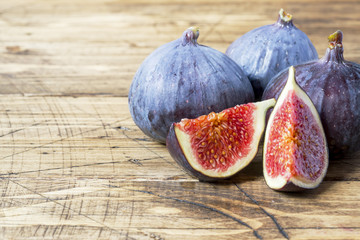 Figs are Fresh ripe whole and cut into a wooden old background. copy space