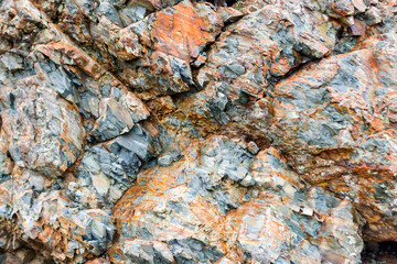 texture of a gray brown stone on the rock of the mountain discovered during archaeological excavations as a monument to millions of years of the formation of cancerous deposits under water
