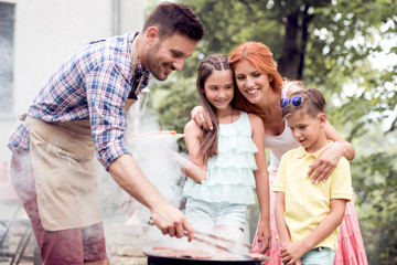 Family on vacation having barbecue