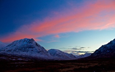 Beautiful Sunset over Snowy Mountains in Scotland, UK