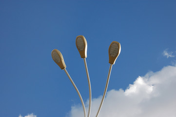 three lanterns against the blue sky