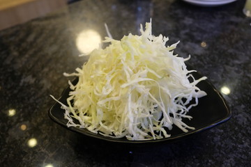 Chopped purple and green cabbage on table.