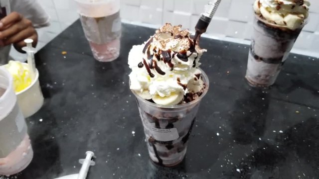 Chocolate ice cream with whip cream and chocolate syrup doused in liquid nitrogen