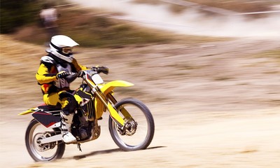 Obraz na płótnie Canvas Rider on bike while Motocross race with motion blur background