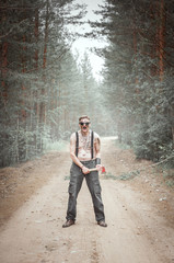 Cannibal steampunk Man in glasses with ax in forest