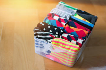 Basket or box with neatly folded colorful socks. Socks or clothes organization and sorting method. 