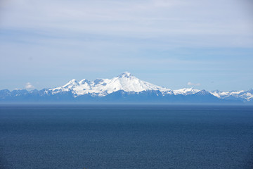 Fototapeta na wymiar Several volcanic peaks across Cook Inlet in Homer Alaska