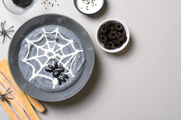 Black Hummus Halloween Dip Decorated with Cobweb and Spider, Halloween Party Treat