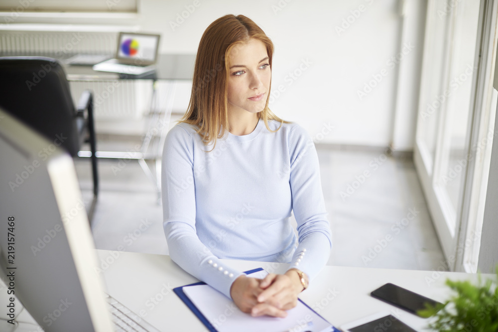 Wall mural thinking young businesswoman portrait