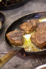cooking fresh steak in kitchen
