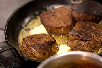 cooking fresh steak in kitchen