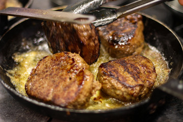 cooking fresh steak in kitchen