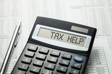Tax help. On display of calculator is written tax help - obrazy, fototapety, plakaty