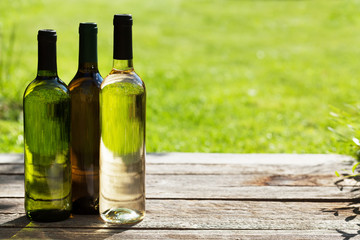 White wine bottles on wooden table