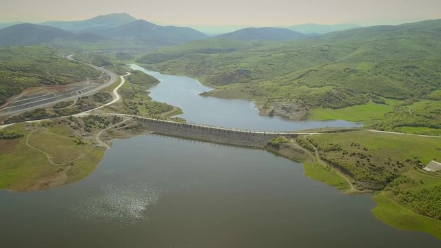 Aerial view of highway road in Techniti Limni Smokovou lake in Greece.