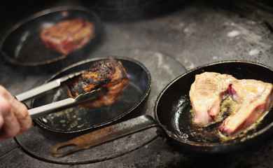 cooking fresh steak in kitchen