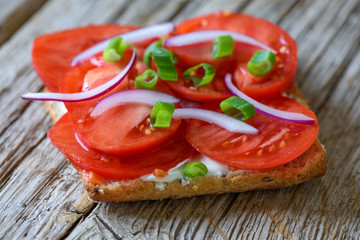 Fototapeta na wymiar Tomato sandwich on wooden background