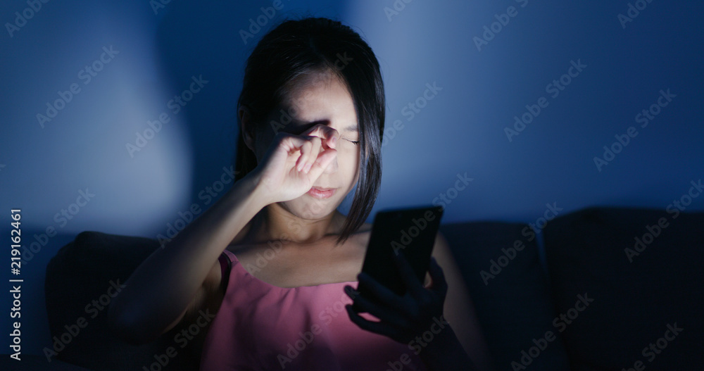 Poster Woman use of cellphone and feeling eye pain at night