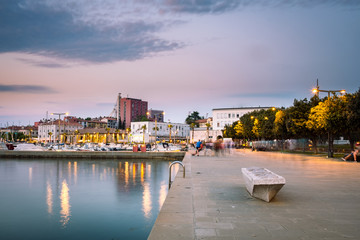 A promenade by the sea in harbour in the city of Koper, Slovenia after sunset - obrazy, fototapety, plakaty