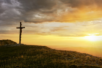 An Evocative Religious Cross on the Mountain Peak at the Sunset Time with View of the Sea