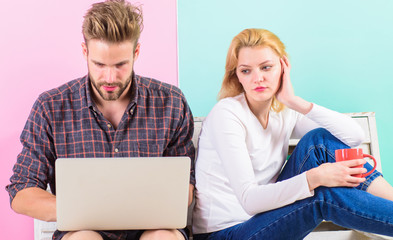 Feeling lonely near him. Woman sad face sit near man with laptop. Girl feels sadly man not pay...