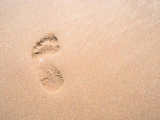 close up footprint on sand at the beach background