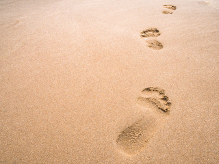 close up footprint on sand at the beach background