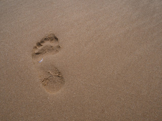 Fototapeta na wymiar close up footprint on sand at the beach background