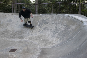 Caucasian Men tattooed skateboarder