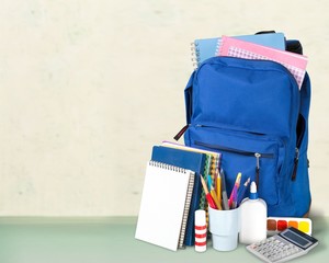 Colorful school supplies in backpack