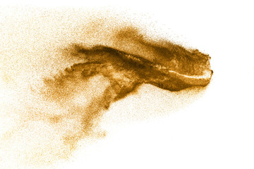 Dry river sand explosion. Golden colored sand splash agianst white background.