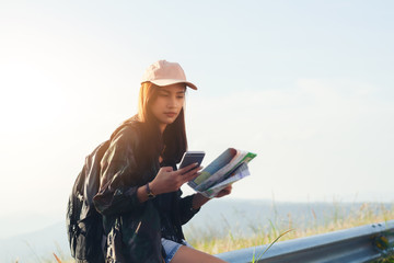 Asian  young women people Hiking with friends backpacks walking together and looking map and taking...