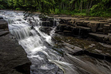 Scenic Michigan Waterfall Landscape. Beautiful Quartzite Falls flows through a gorge on the Slate River in the Upper Peninsula County of Baraga.