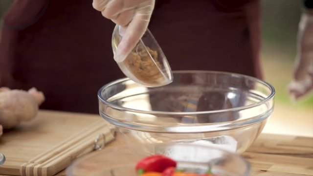 Pouring Spices into Bowl
