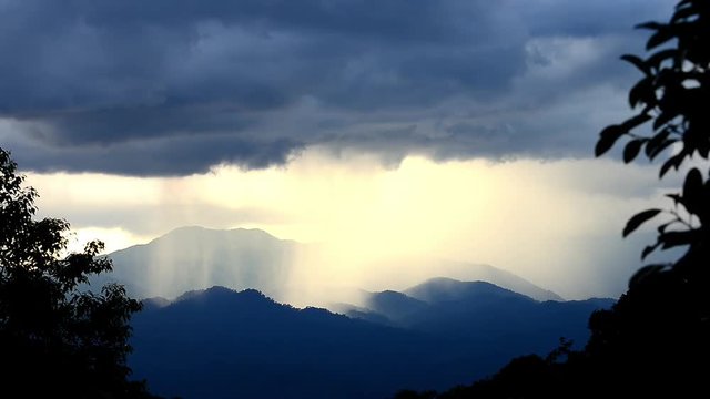 Raining in mountain. Storm rain is falling down in mountain range at sunset in tropical rainforest,hd video. 
