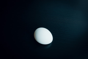Chicken egg on dark table