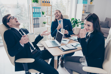 Three modern elegant classic business people laughing loudly, en