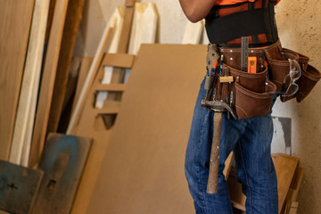 Man with tool belt in a workshop