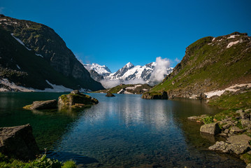 Obraz premium Swiss alps water reflection in Lac de Louvie - mountain lake above Val de Bagnes valley, Switzerland.