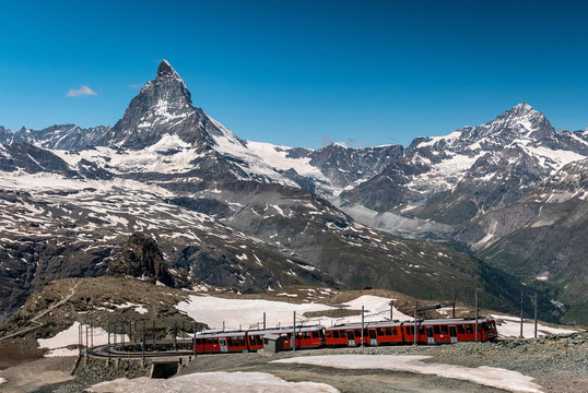 Gornergrat tourist train with Matterhorn mountain in the background. Valais region, Zermatt, Switzerland.