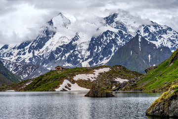 Obraz premium Swiss Alps water reflection in Lac de Louvie - mountain lake above Val de Bagnes valley, Switzerland.