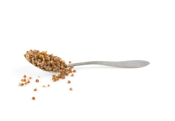 buckwheat porridge on a metal spoon on a white background